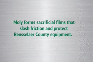 Minimalist vector graphic with gunmetal background and bright Metallic Green text reading “Moly forms sacrificial films that slash friction and protect Rensselaer County equipment.” 